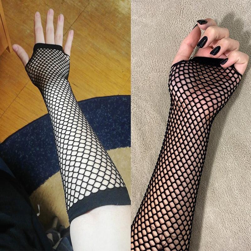 Black fishnet arm sleeves shown in two lifestyle angles: worn on forearm with large mesh pattern, styled for gothic, alternative, and femboy fashion outfits.