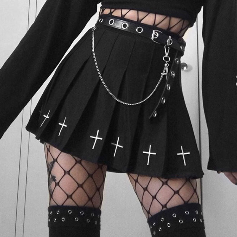 Black gothic cross pleated skirt with chain belt, alternative femboy clothing aesthetic featuring layered textures and bold monochrome styling