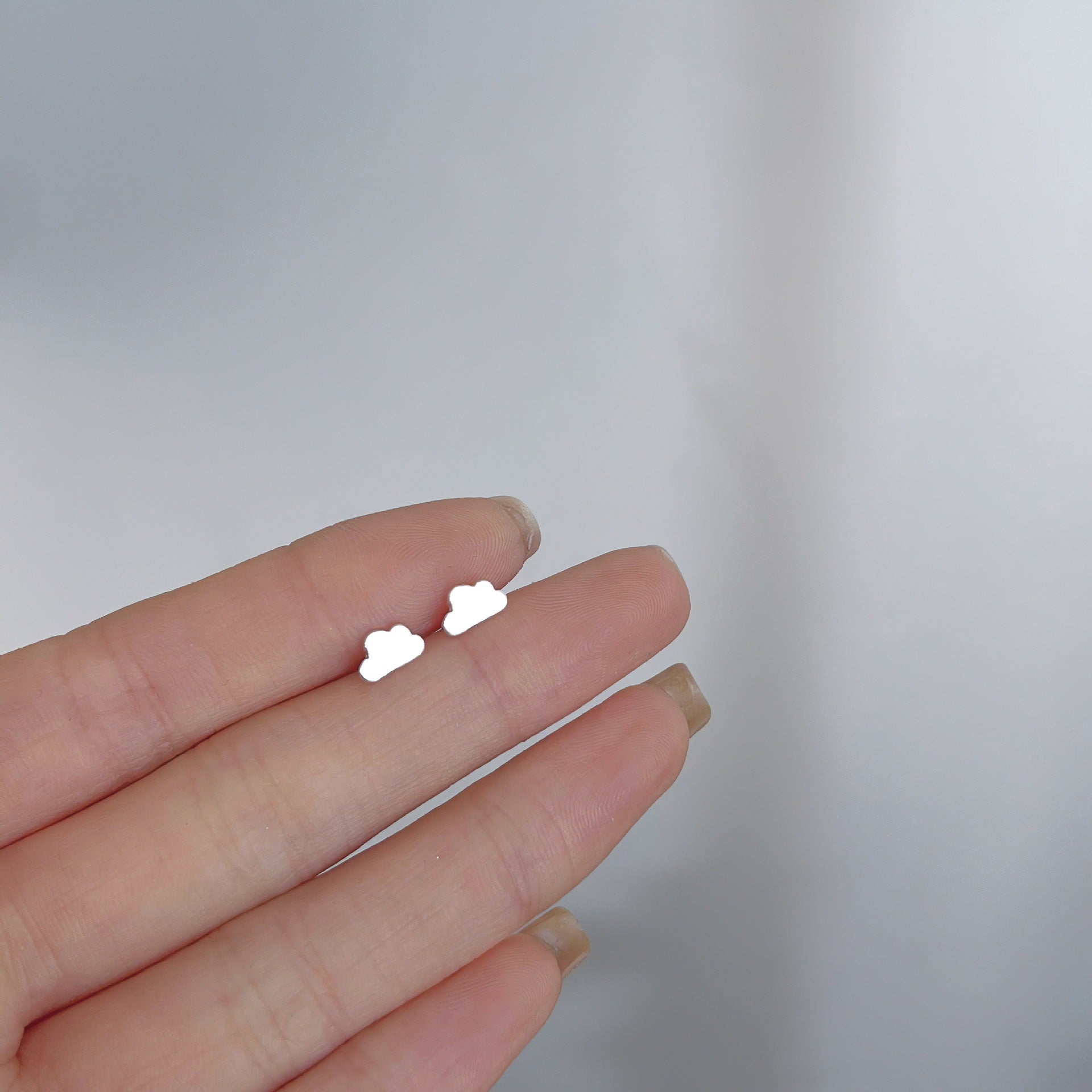 Cloud-shaped silver earrings, adding a playful and unique flair to any femboy clothing collection.