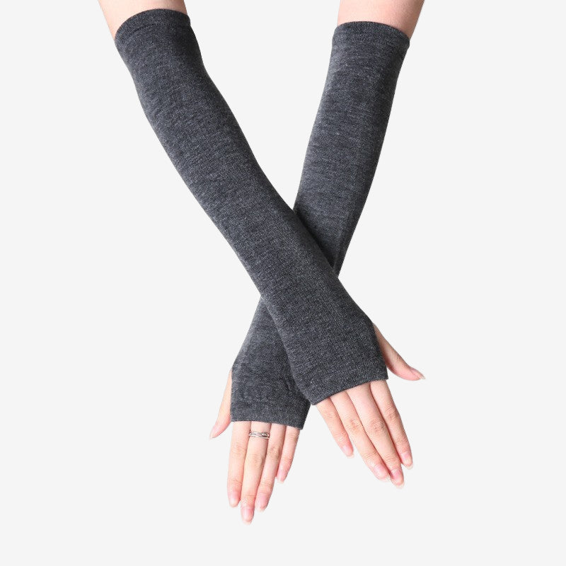 Close-up of hands in dark grey fingerless arm warmers, long and comfortable for added warmth. Perfect for femboy fashion and adding a unique touch to femboy clothes.