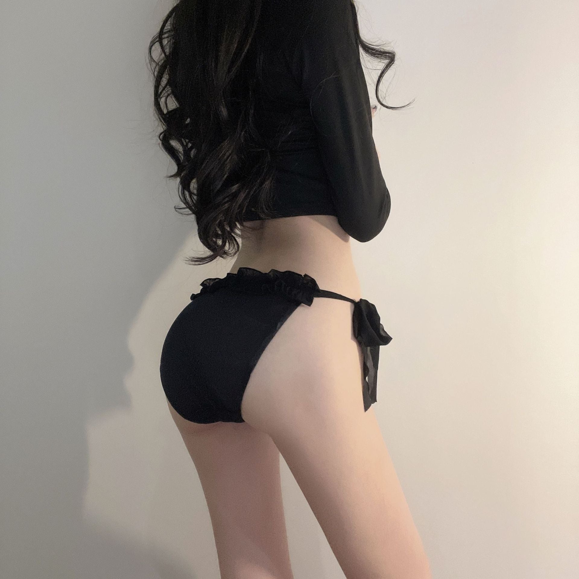 A rear view of the black Bowknot Mesh Panties, featuring a chic black bow and delicate mesh fabric. This intimate look captures the elegance of femboy fashion, enhancing femboy outfits.