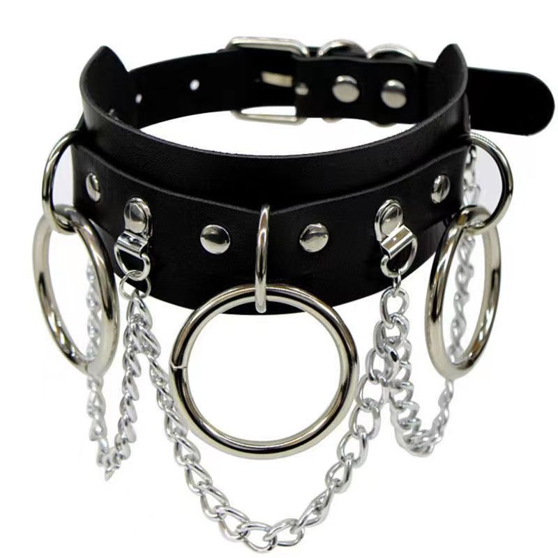 Black gothic femboy choker with silver O-ring and hanging chain details, straight-on product shot highlighting layered leather straps and metal hardware, edgy femboy accessory for alternative and gothic femboy outfits.