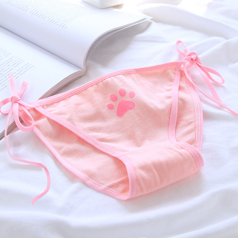 Close-up of pink Paw Panties on a white background, featuring a bright pink paw print design. These femboy panties add a sweet, playful element to femboy outfits and femboy fashion.