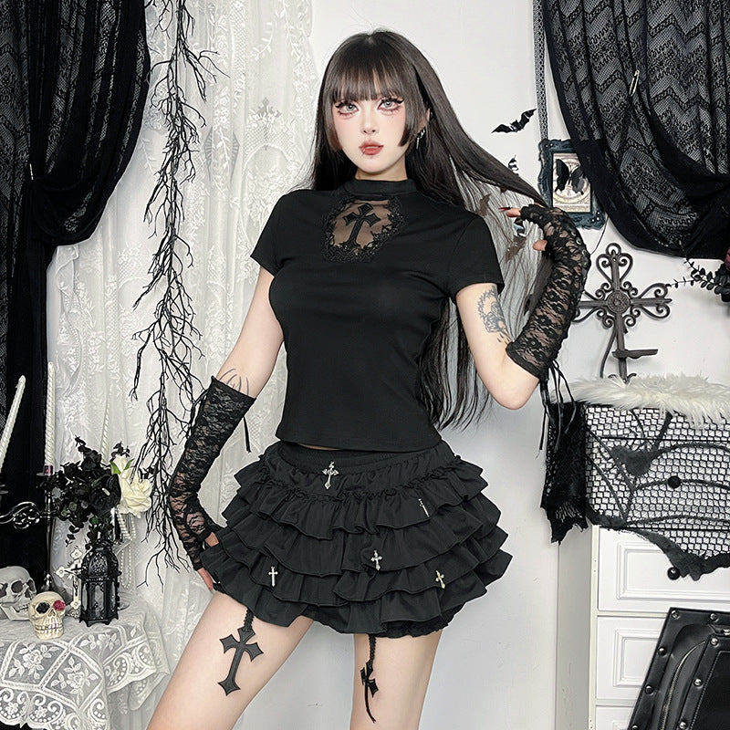 Full-body portrait of model in gothic femboy skirt outfit with ruffled black mini skirt, cross details, and lace gloves – stylish femboy clothing online
