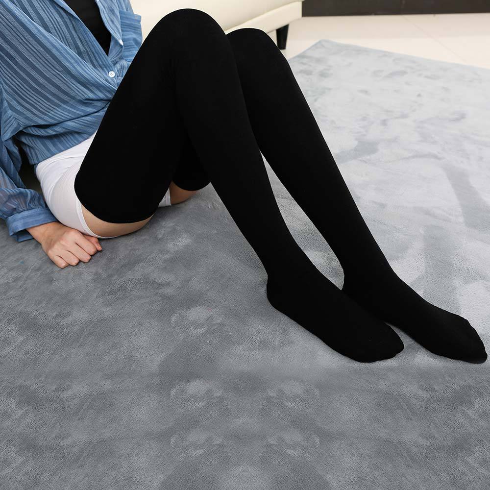 full body seated shot of black extra long cotton femboy stockings, emphasizing sleek stretch material and long-line silhouette for modern femboy clothes styling