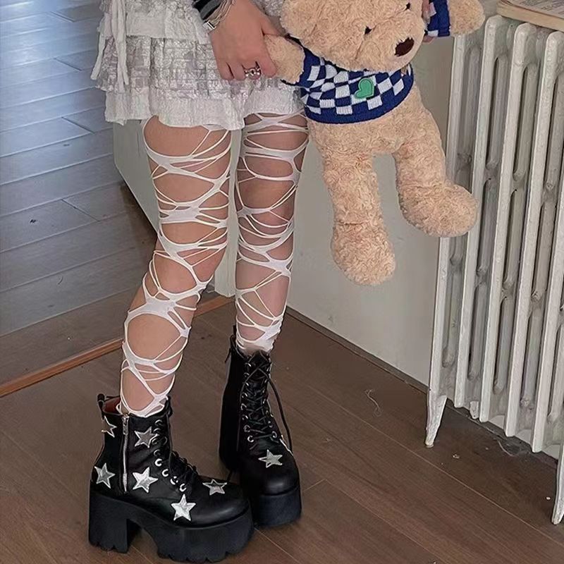 White gothic punk fishnet tights with torn cutout pattern, alternative femboy outfits styling, paired with casual streetwear pieces
