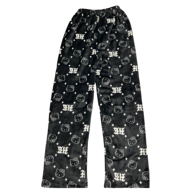 Black Hello Kitty print pajama pants laid flat on a white background, featuring repeated Hello Kitty face icons and gothic-style monogram lettering, soft fleece fabric with a relaxed straight-leg fit for cozy femboy outfits.