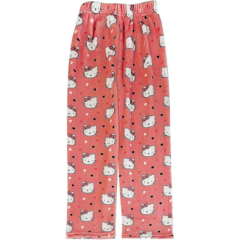 Pink Hello Kitty print pajama pants laid flat, decorated with repeating Hello Kitty faces and small heart motifs, plush fleece texture with elastic waist and straight-leg silhouette for cute femboy outfits.