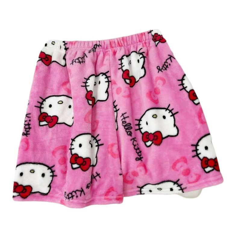 Flat lay product photo of pink plush Hello Kitty print shorts with big white Hello Kitty face silhouettes, red bows, and “Hello Kitty” text; elastic waist; isolated on a white background, soft lounge femboy clothing for femboy outfits.