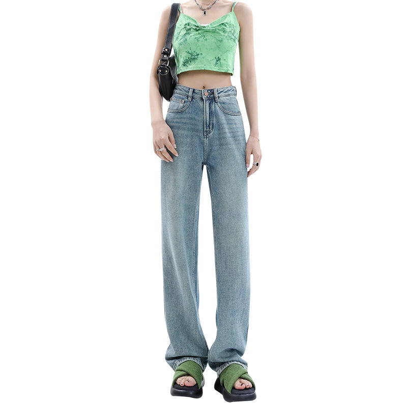 Full-body shot of a model wearing high-waist femboy jeans and a green crop top, standing against a white background.
