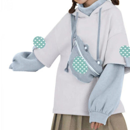 Close-up of a playful light blue Vacuum Bear Hoodie featuring a bear-shaped vacuum pouch, ideal for enhancing any femboy outfit. The hoodie is styled with a contrasting grey pouch, adding a fun twist to the design.