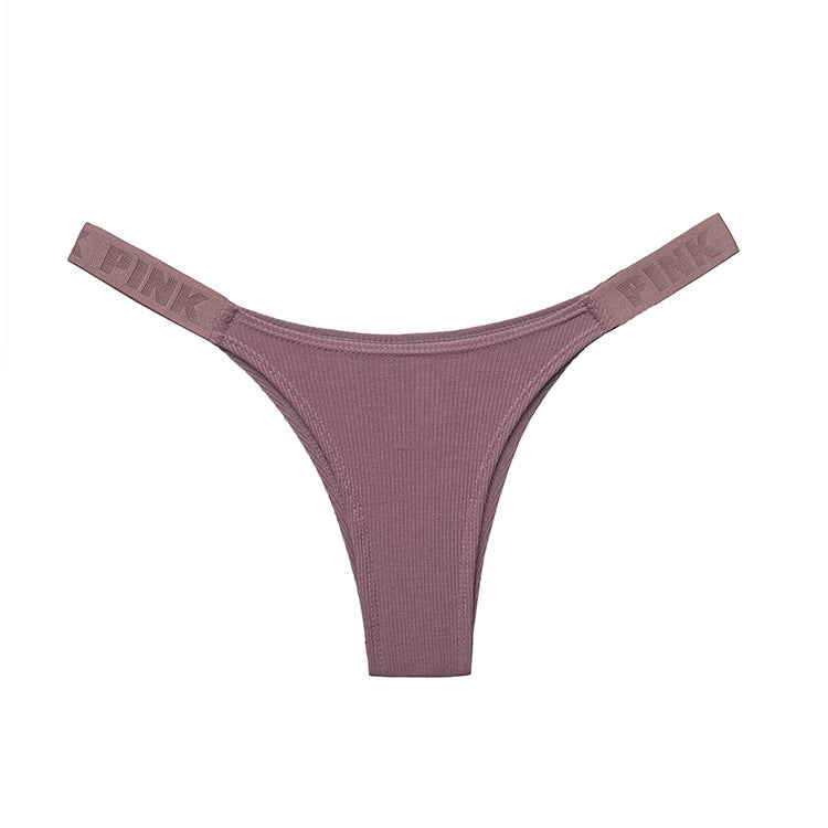 Top-down product shot of mauve seamless femboy briefs with ribbed detailing and matching elastic straps, clean white studio background