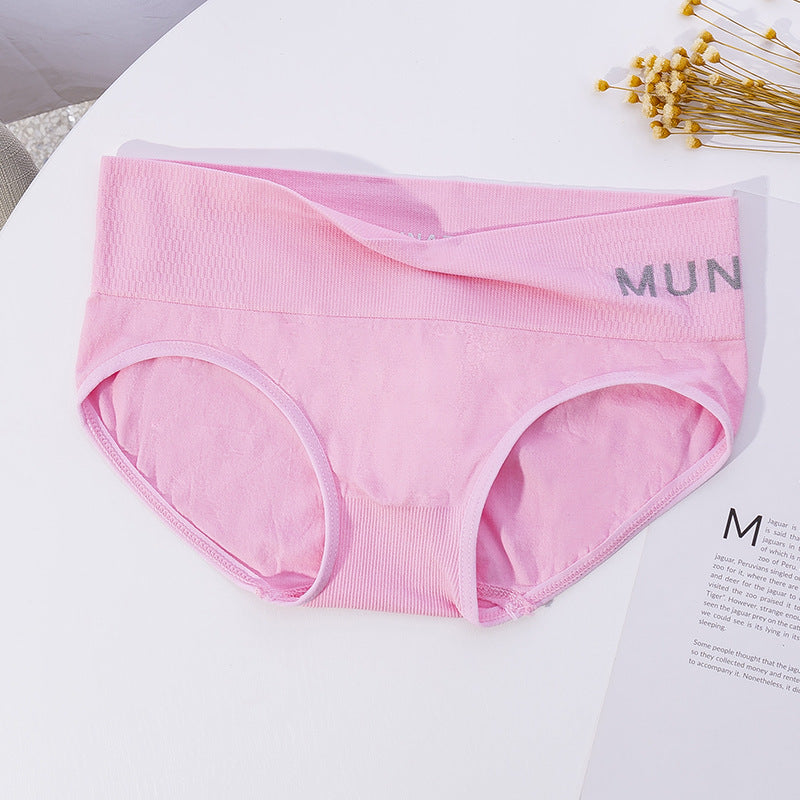 Close-up of pink Solid Sport Panties against a white surface with small decor elements. The focus is on sporty, stylish femboy clothes that combine functionality and fashion.
