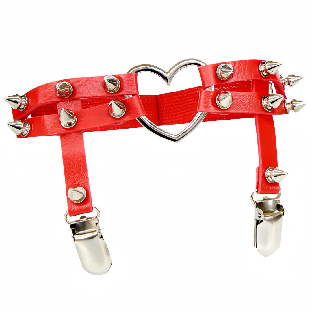 Studio product image of the red Studded Heart Femboy Thigh Garter photographed from a straight-on angle on a white background, featuring glossy red faux leather, silver spike studs, adjustable straps, and heart-shaped metal hardware, designed for bold and sexy femboy outfit styling.