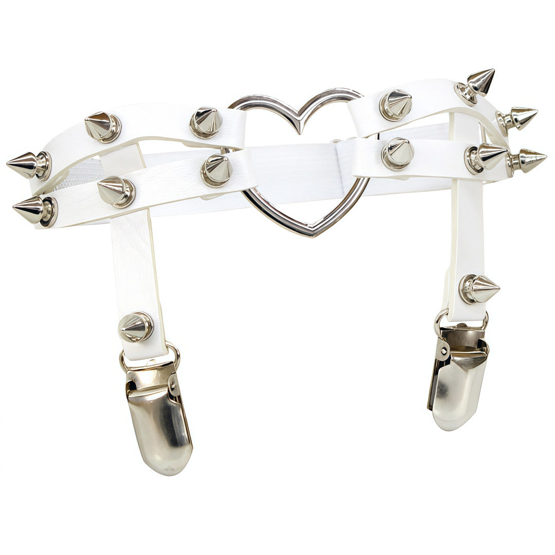 Clean studio flat-lay style shot of the white Studded Heart Femboy Thigh Garter captured from a straight-on angle, highlighting smooth white faux leather, reflective spike studs, elastic backing, and a polished heart centerpiece, a minimal and aesthetic femboy thigh garter.