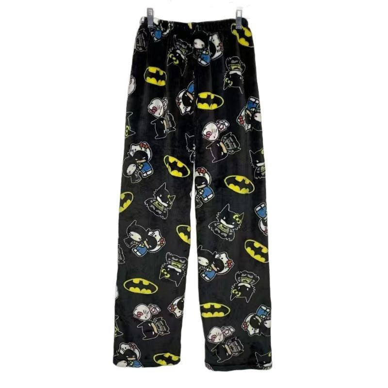 Black fleece lounge pants with all-over cartoon character prints laid flat on a white background, featuring playful graphic designs and a relaxed fit suitable for cozy femboy outfits.