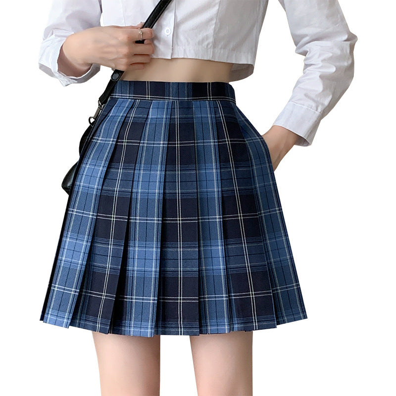 Close-up front view of a high-waisted blue pleated femboy student skirt paired with a white crop shirt. Ideal for femboy fashion enthusiasts, this skirt embodies the classic schoolgirl style.