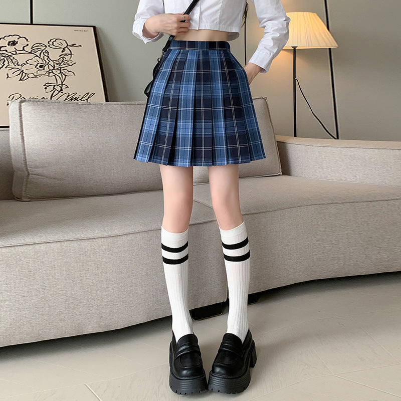 Elegant blue femboy student skirt worn with knee-high striped socks and black loafers, creating a chic, schoolgirl-inspired outfit ideal for femboy fashion fans.