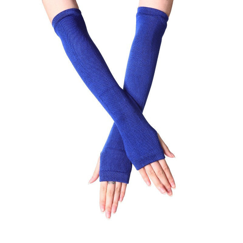 Close-up of hands in vibrant blue fingerless knit arm warmers, perfect for adding style to femboy outfits. These long gloves are a great addition to femboy fashion.