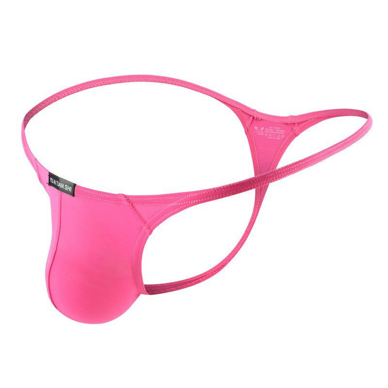 Product close-up of a pink breathable femboy thong on a clean white background, angled side view showcasing the slim waistband and soft contour pouch; minimalist aesthetic for femboy clothing, femboy outfits, and femboy fashion.