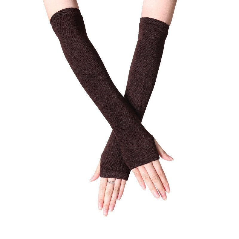 Close-up of hands in brown fingerless knit arm warmers, offering a cozy style for autumn and winter femboy outfits. A great addition to femboy clothes collection.