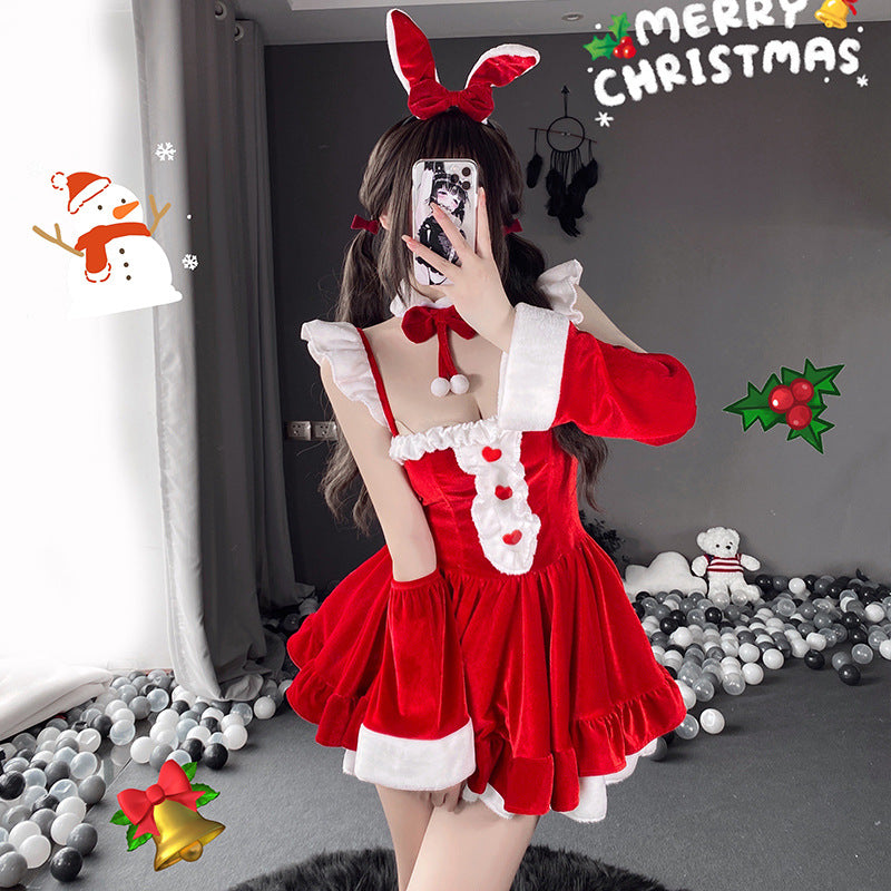 Full-body shot of a Christmas femboy outfit, showcasing a red velvet dress with white accents, a bunny ear headband, and holiday decor in the background, with the "Merry Christmas" text overlay adding seasonal charm.