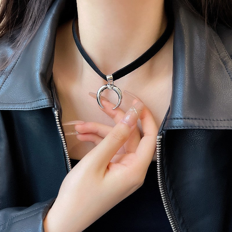 Close-up of a crescent moon pendant choker necklace with black leather, paired with a leather jacket for a stylish femboy outfit. Completes a gothic-inspired femboy look.