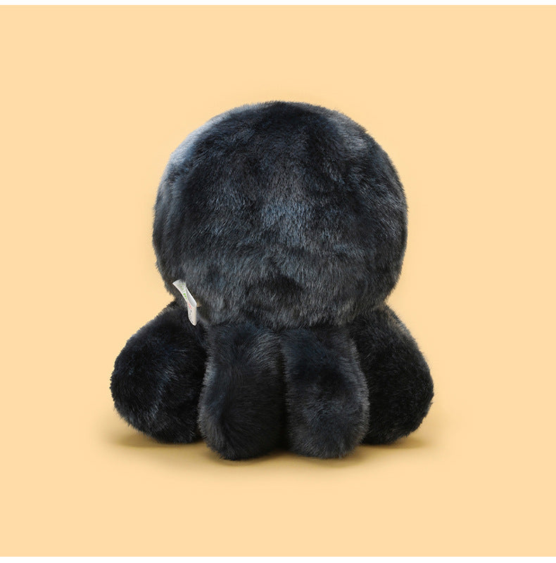 Rear view of a dark grey cute spider plush showing rounded plush body, soft fuzzy texture, and four plush legs, photographed on a clean pastel yellow background.