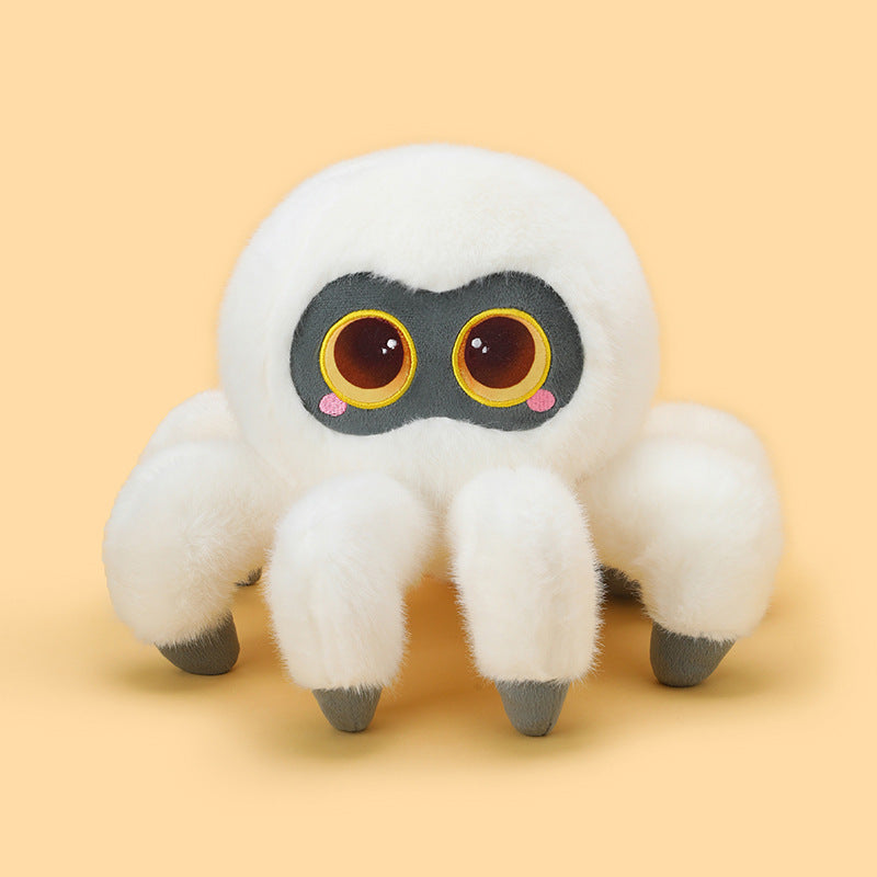 Front view of a white cute spider plush with ultra-soft fluffy texture, oversized cartoon eyes, rounded plush body, and grey-tipped legs on a pastel yellow background.