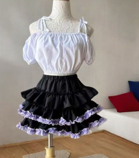 Black tiered femboy skirt with lavender ruffle trim styled on mannequin, three-quarter front view showing layered silhouette and soft punk aesthetic, designed for gothic femboy outfits and alternative femboy clothing.