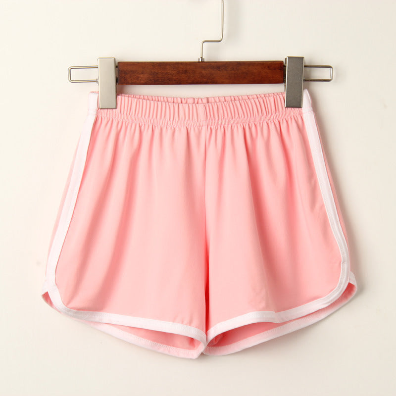 Close-up of pink Dolphin Shorts with a minimal white background, showcasing the soft fabric and elastic waistband. Perfect for femboy outfits and femboy fashion enthusiasts looking for a sporty, casual style.