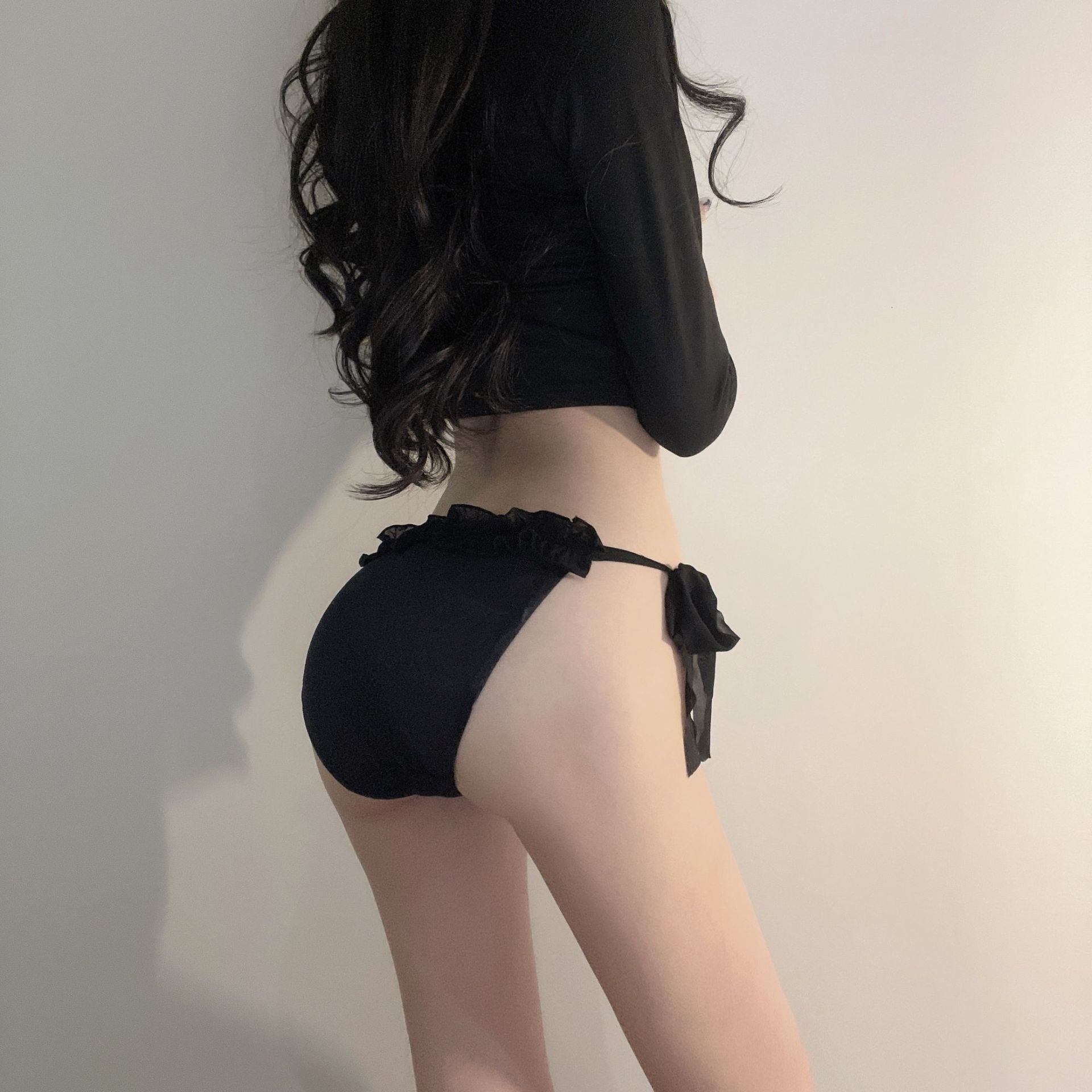 A rear view of the black Bowknot Mesh Panties, featuring a chic black bow and delicate mesh fabric. This intimate look captures the elegance of femboy fashion, enhancing femboy outfits.

