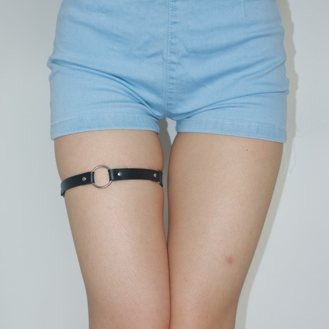 Femboy fashion leather round metal garter styled with light blue shorts, perfect for femboy clothing and accessory combinations.