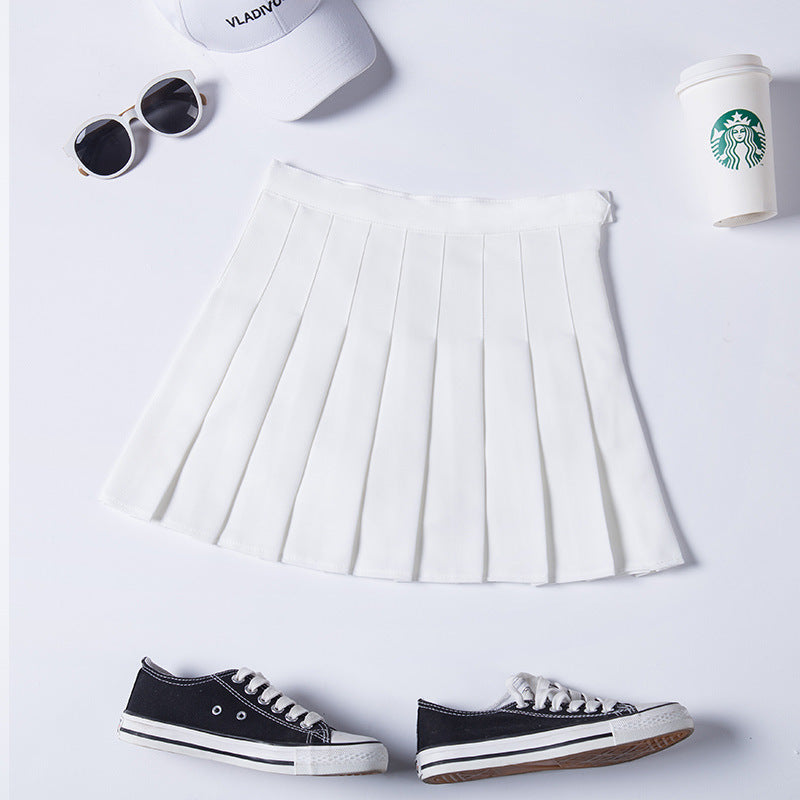 Minimalistic white high-waist pleated mini skirt paired with trendy sneakers, ideal for creating fresh femboy outfits for warm weather.