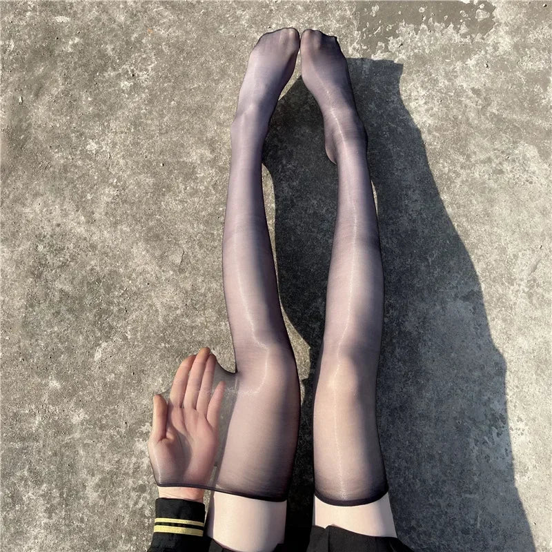 Black glossy ultra-thin thigh highs flatlay, femboy aesthetic hosiery close-up