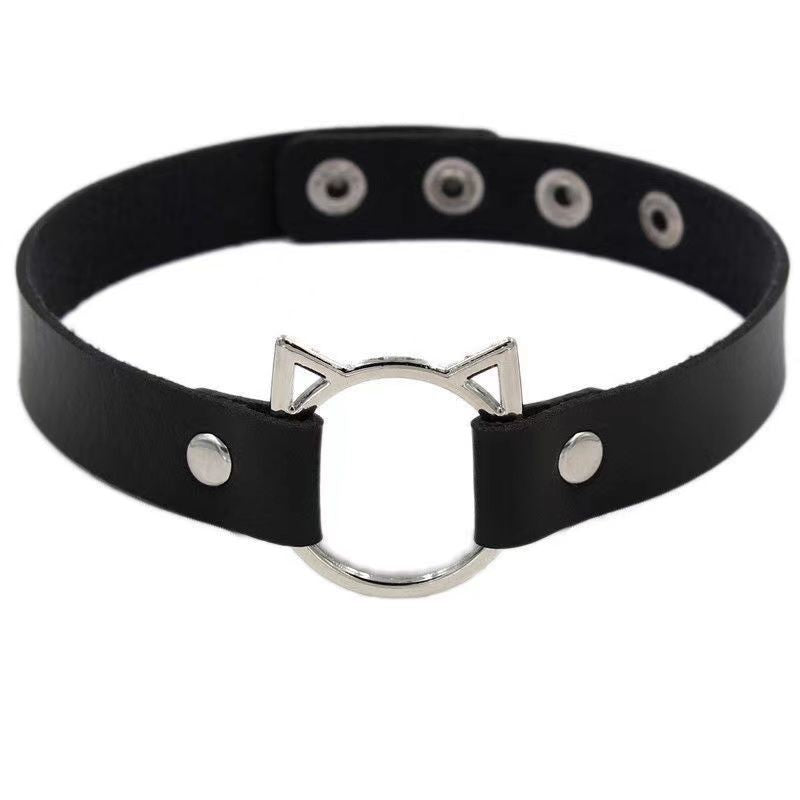 Black leather femboy choker with silver cat ear O-ring detail, close-up studio image on white background, cute gothic femboy fashion choker
