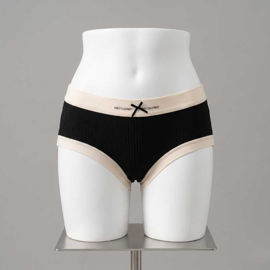Black JK style modal femboy panties with cream contrast trim and ribbon bow waistband, ribbed fabric from FemboyBox