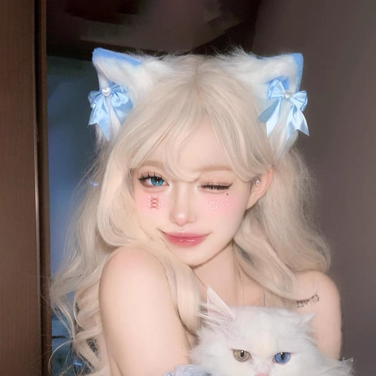 Blue bow lolita cat ear clip set worn with white hair, cute kawaii femboy accessory from FemboyBox