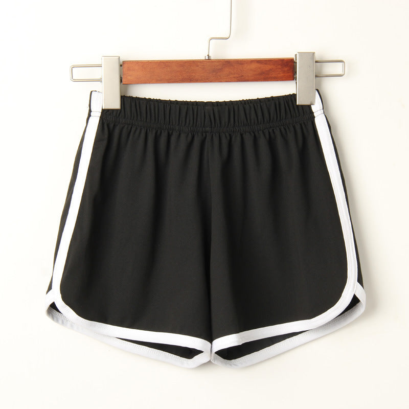 Black Dolphin Shorts with white lining, neatly hanging on a hanger against a neutral white background. Ideal for femboy outfits and everyday femboy clothes.