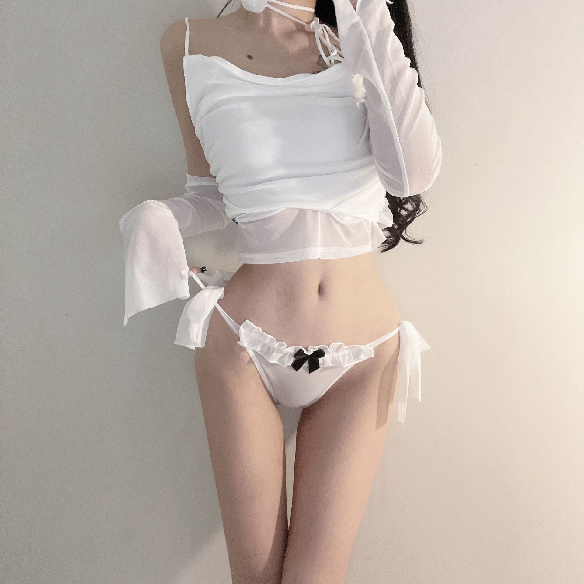 A full-body shot of a model showcasing the white Bowknot Mesh Panties, styled with a white crop top. This femboy outfit highlights the soft ruffled details and black bow accent, making it a favorite in femboy fashion.