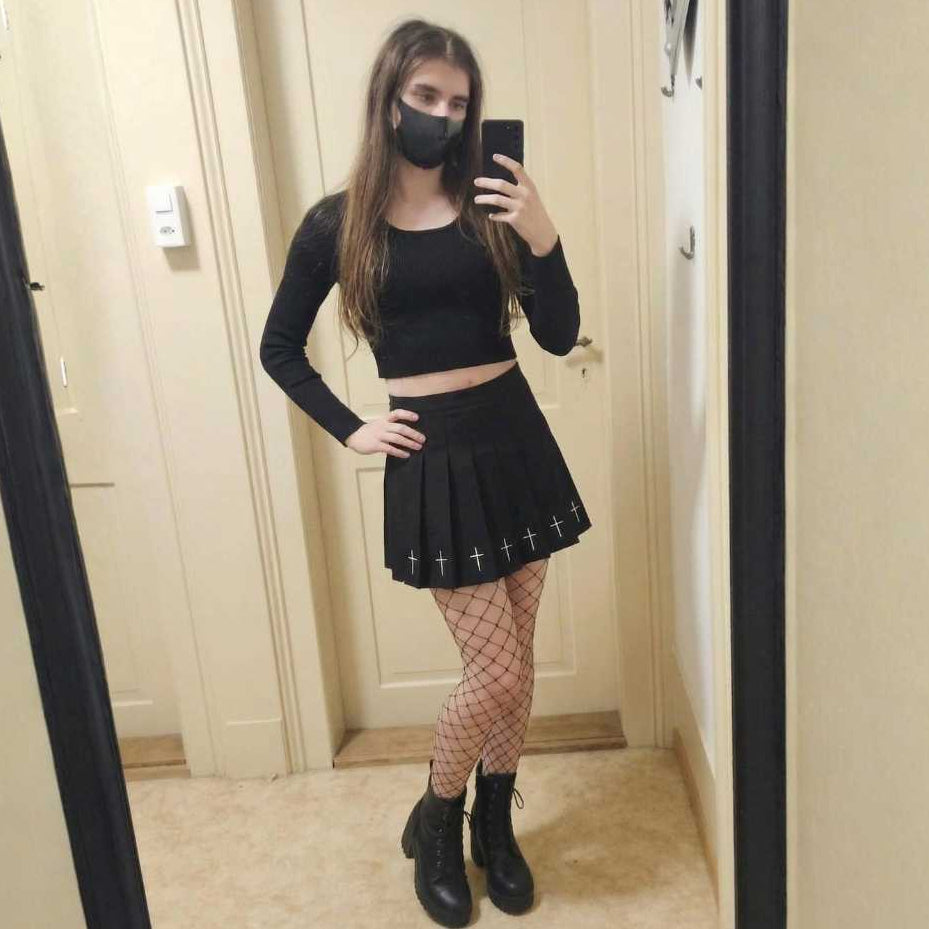 Goth femboy kit mirror selfie with black crop top, pleated mini skirt and fishnet tights from FemboyBox