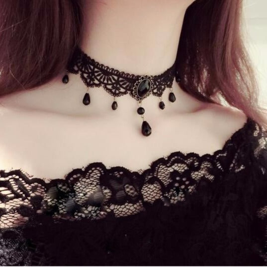 Black gothic lace choker with intricate lace detailing and dangling bead accents, dark elegant femboy fashion jewelry