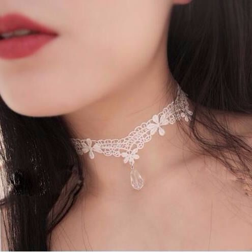 White gothic lace choker with delicate floral lace design and teardrop crystal pendant, soft elegant femboy accessory aesthetic