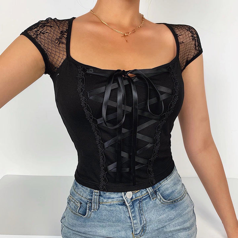 eye-level medium shot of a model gently twirling a flared black skirt while wearing a lace-panel crop top in a white room, perfect example of femboy outfits.