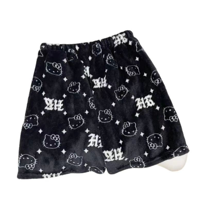 Black Hello Kitty print femboy shorts featuring repeating Hello Kitty faces and gothic monogram pattern on soft plush fabric, flat lay product image for femboy clothing and femboy outfits.