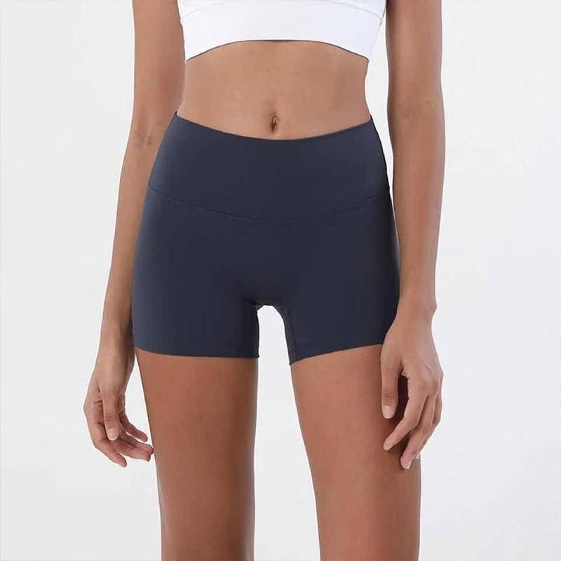 Front view of navy blue yoga shorts on a model against a plain background. The image emphasizes the shorts' high waist and form-fitting design, from the waist to the thighs.