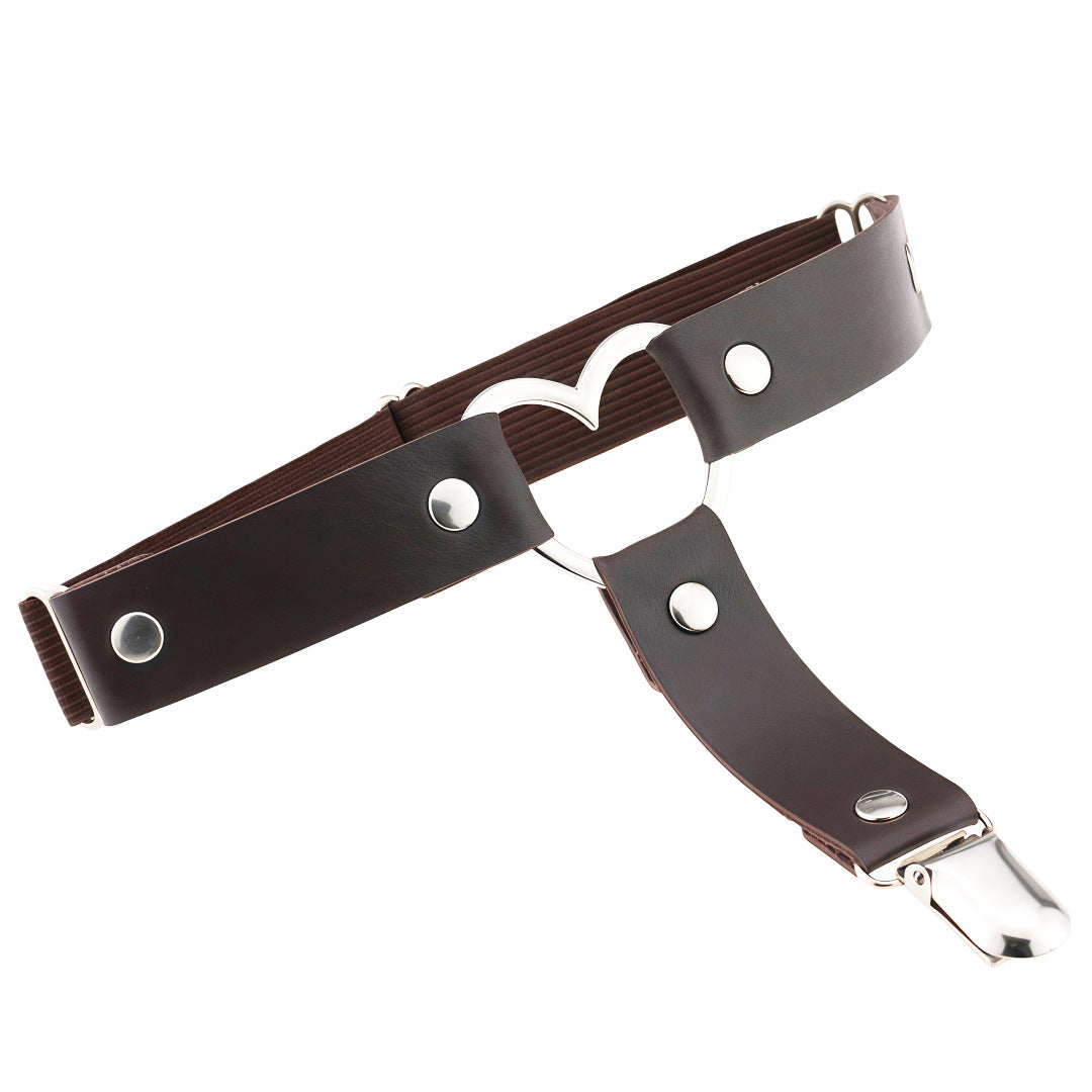 Brown leather heart femboy thigh garter with silver heart ring and adjustable strap, minimalist femboy fashion accessory on white background