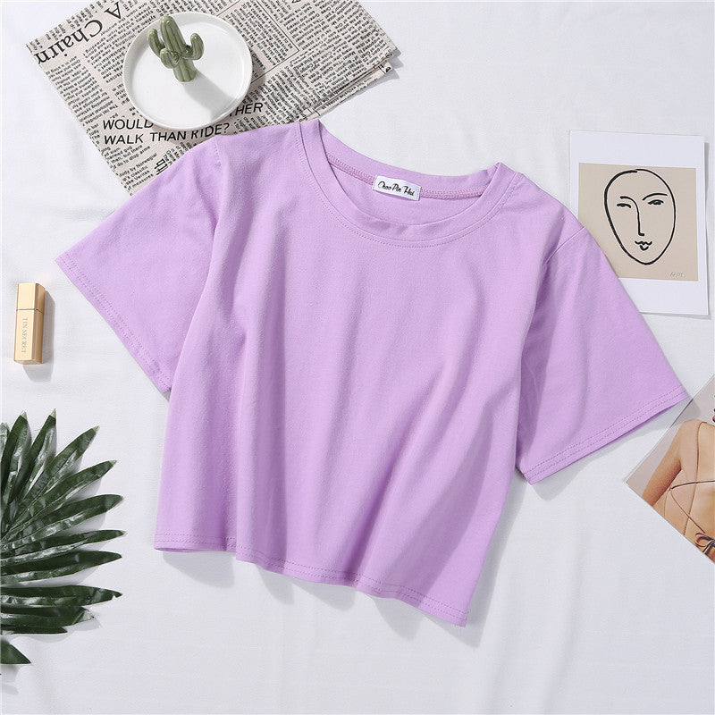 A flat lay of a light purple Loose Crop Top Tee on a clean, modern surface. Ideal for casual femboy clothes, this tee brings a relaxed yet fashionable look to any wardrobe.