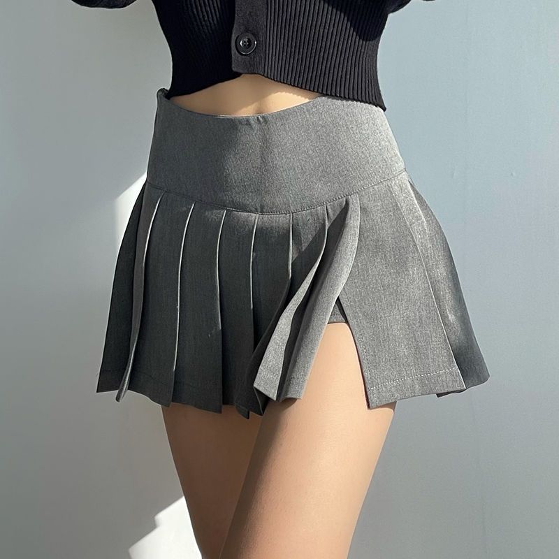 Side view of a gray pleated half skirt showcasing its dynamic pleats and wrap-around design, ideal for those who appreciate sophisticated femboy fashion.