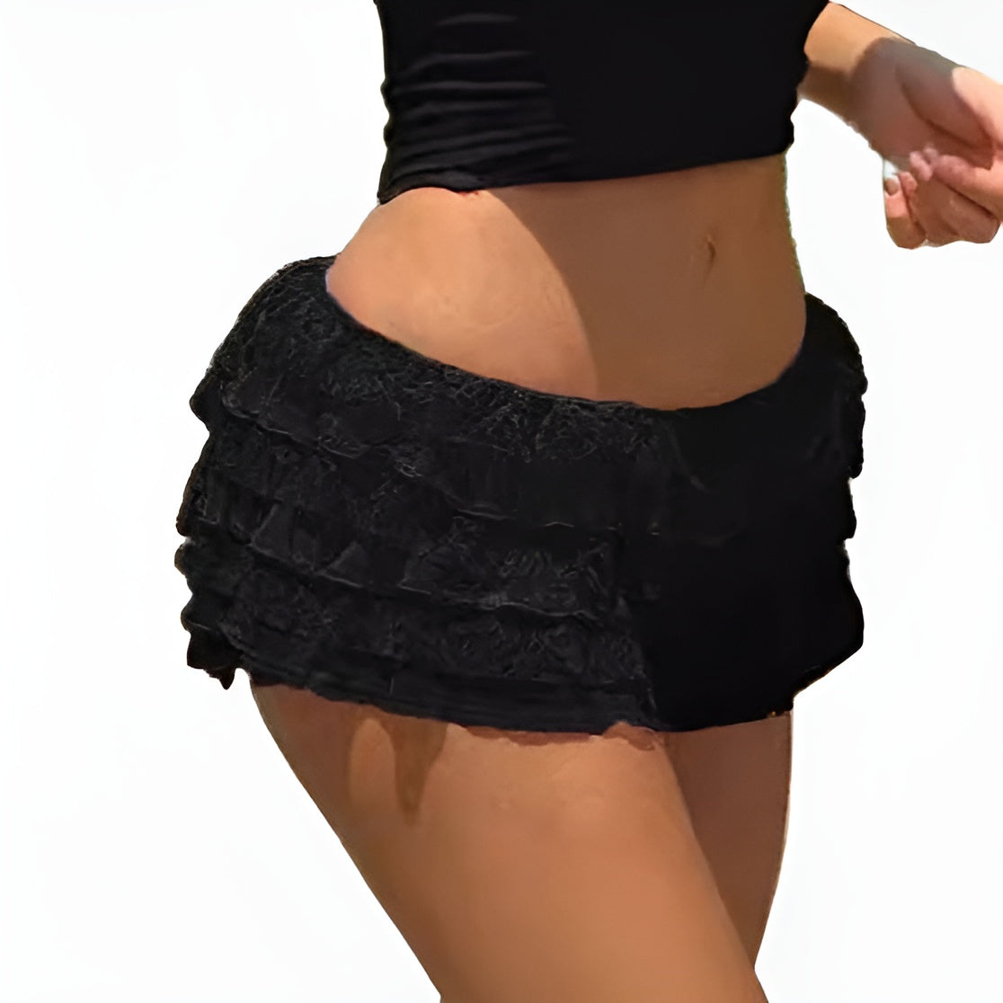 Front side view of black tiered lace skirt-pants styled in a complete femboy outfit, featuring a black lace design with subtle black details. Taken in garden lighting with a natural background.